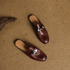 Maroon leather mules with silver buckle hardware and rounded toe