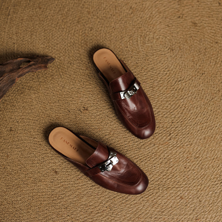 Maroon leather mules with silver buckle hardware and rounded toe