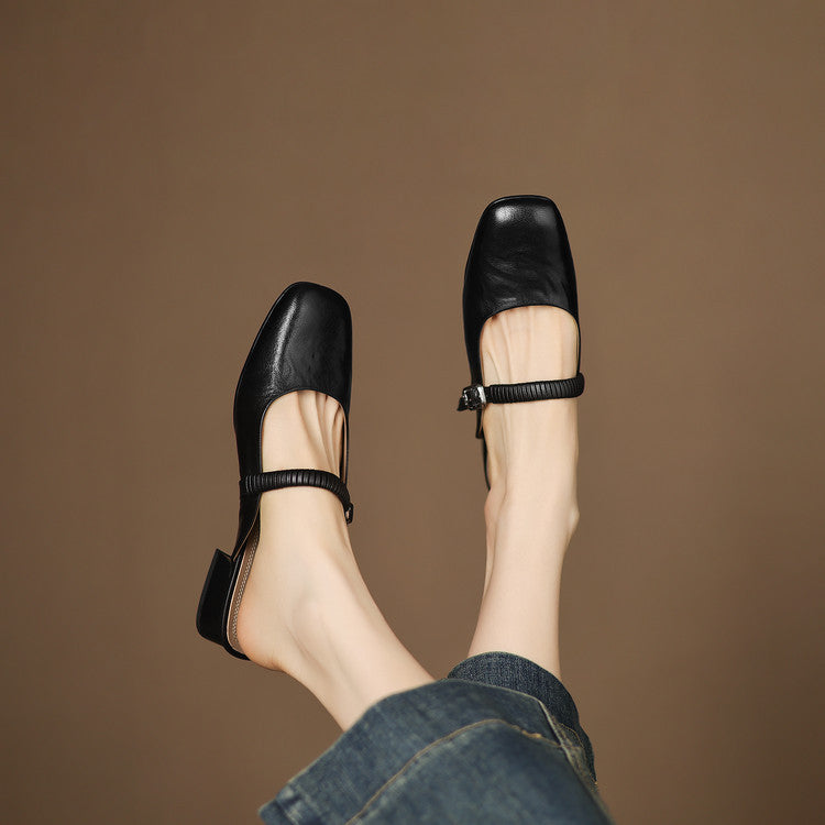 Black leather Mary Jane mule flats with ankle strap and metal buckle detail
