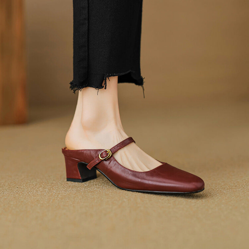 Maroon leather mule with low block heel and slip-on strap with gold buckle