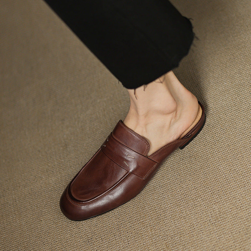 Brown leather slip-on mule with strap across the vamp and rounded square toe