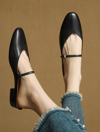 Black genuine leather mules with adjustable buckle strap and low stacked heel