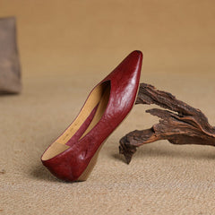 Maroon leather pointed-toe mule with low heel, interior lining visible