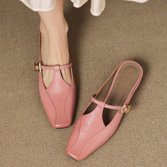 Pink leather mules worn with sling strap and gold buckle, open heel, low heel