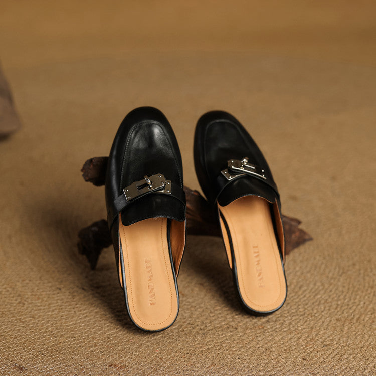 Black mules with silver buckle strap and cushioned insole, slip-on style