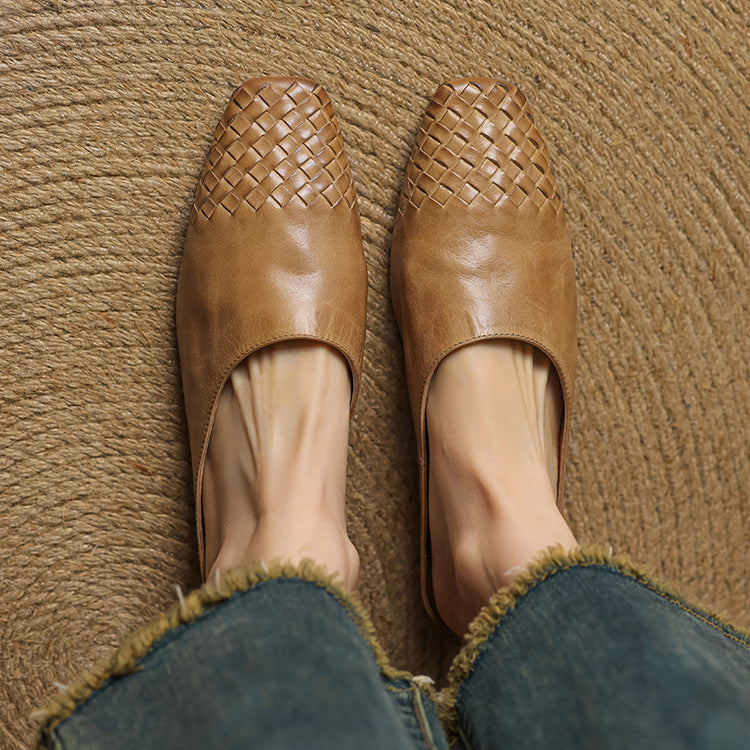Pair of tan genuine leather mules with woven uppers and open side cutouts