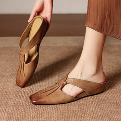 Brown tan square-toe genuine leather mule with strap and low, flat sole.