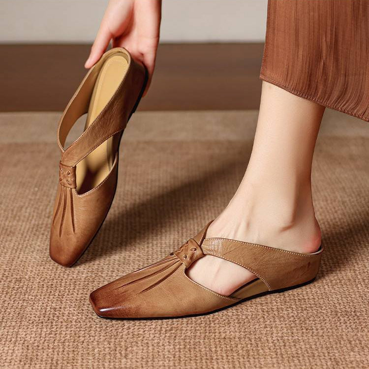 Brown tan square-toe genuine leather mule with strap and low, flat sole.