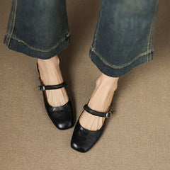 Black leather Mary Jane mule flats with wide ankle strap and round silver buckle