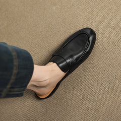 Black genuine leather mule with strap detail across the vamp and rounded toe