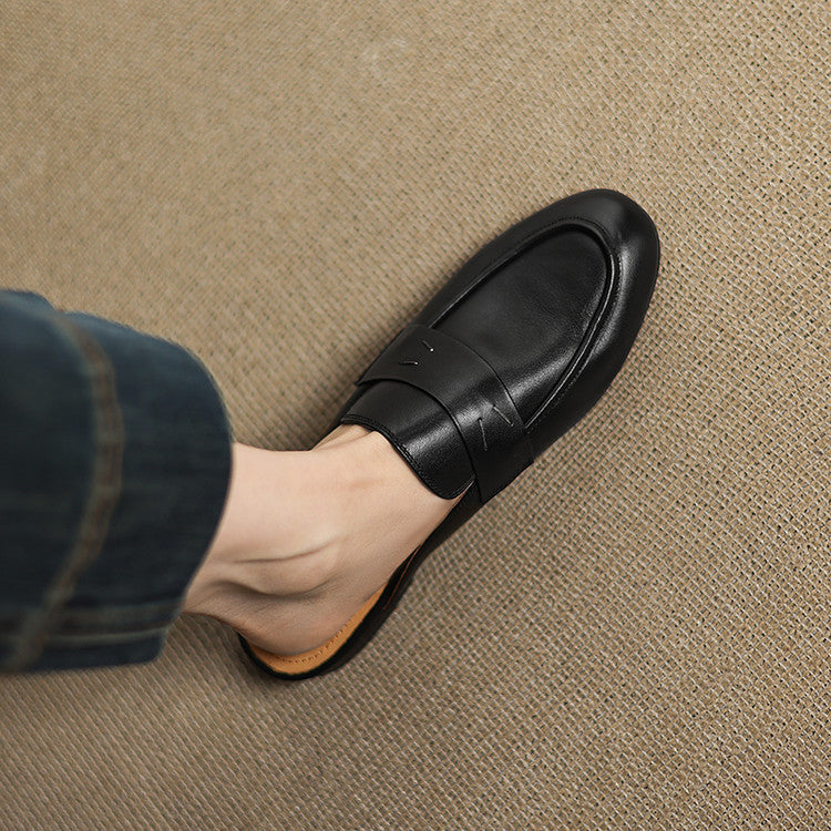 Black genuine leather mule with strap detail across the vamp and rounded toe