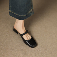 Black leather Mary Jane mule flats with ankle strap, square-toe silhouette