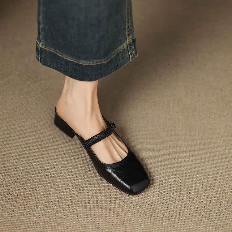Black leather Mary Jane mule flats with ankle strap, square-toe silhouette