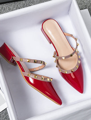 Red patent stud-strap mules with pointed toe and low block heel, side buckle detail
