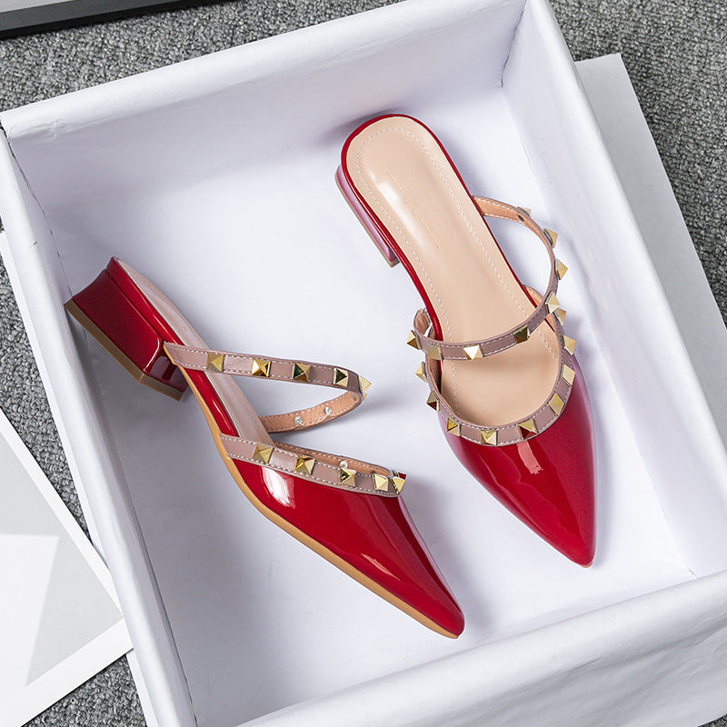 Red patent stud-strap mules with pointed toe and low block heel, side buckle detail