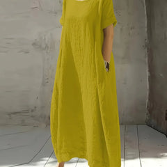 Bright yellow casual maxi dress with short sleeves and round neckline, flowing fit