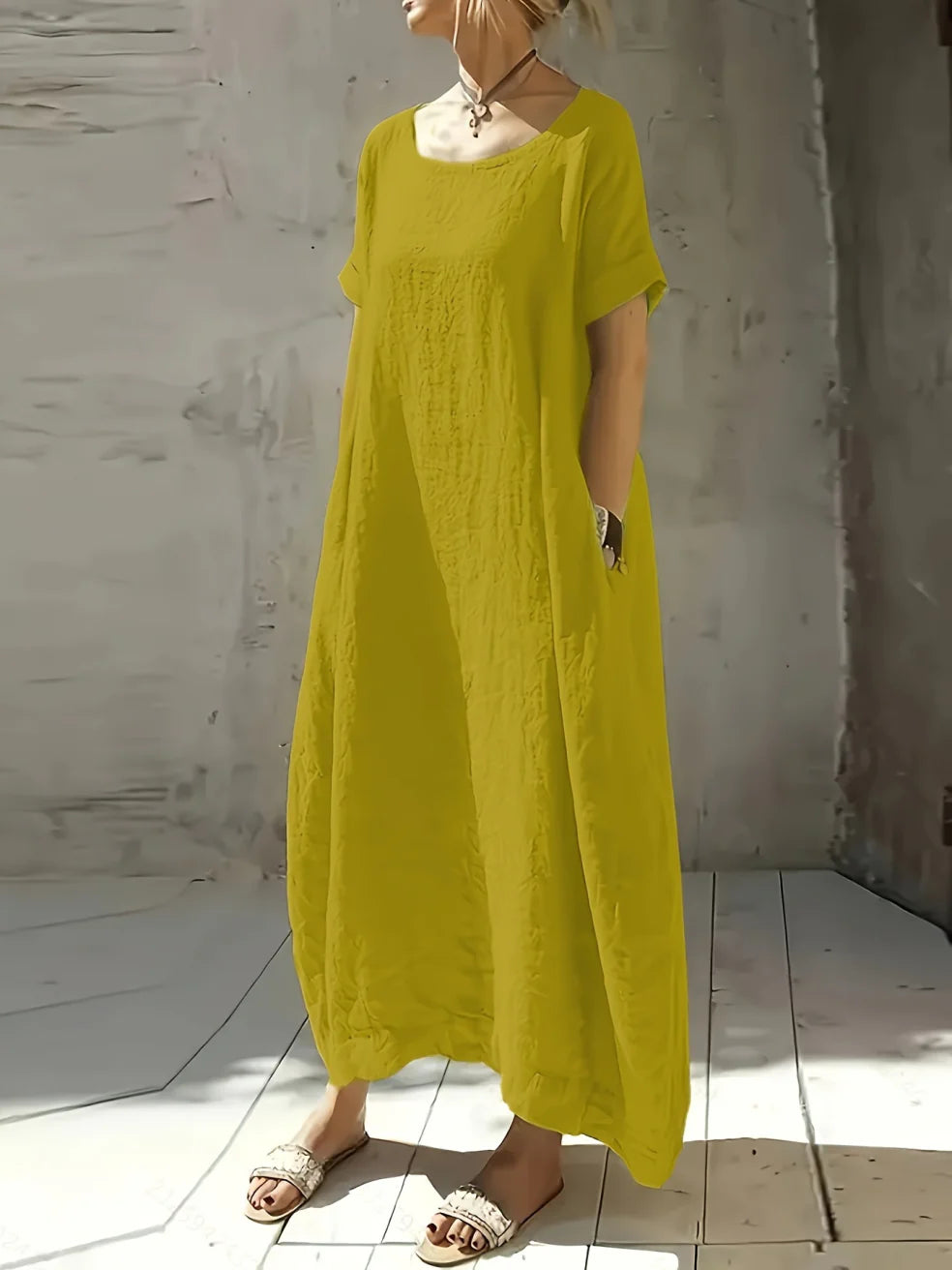 Bright yellow casual maxi dress with short sleeves and round neckline, flowing fit