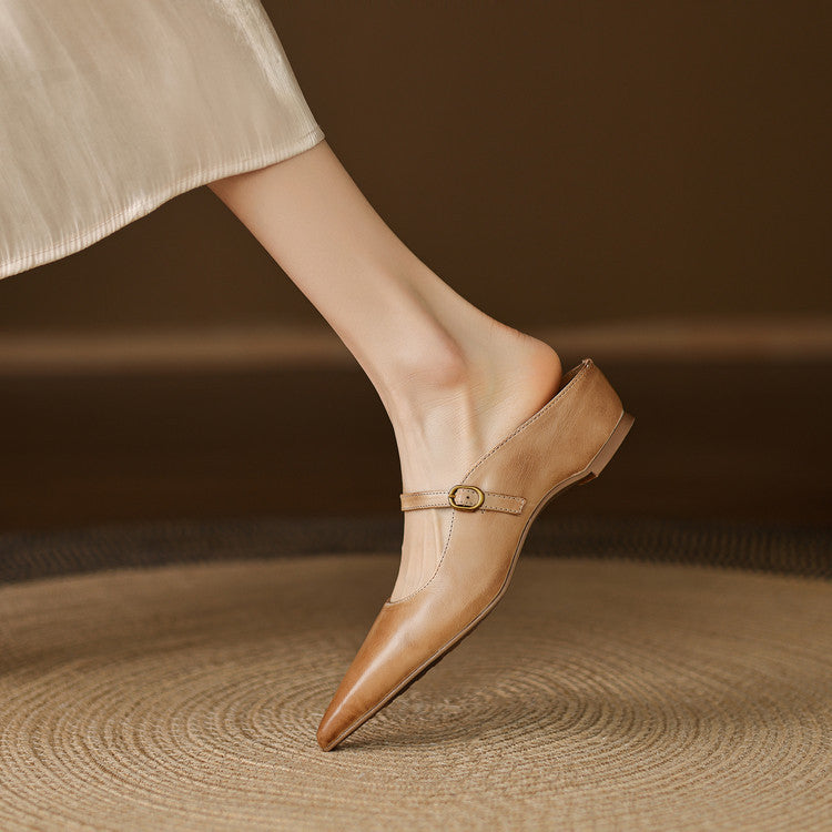 Tan leather pointed-toe mules with ankle strap and round metal buckle