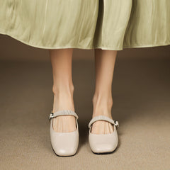 Pair of cream Mary Jane leather mules with elastic-look strap and metal buckle