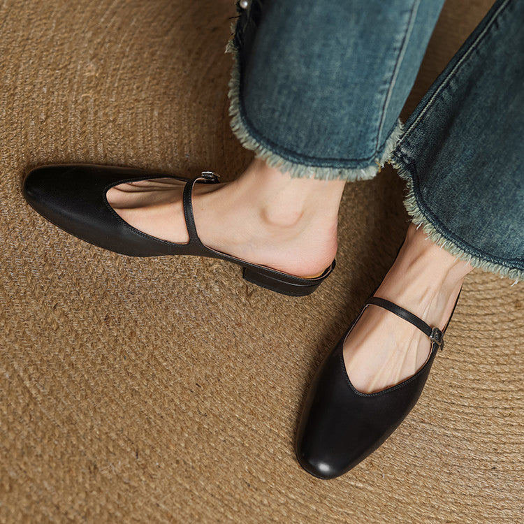 Black genuine leather mules with instep strap and open-toe silhouette