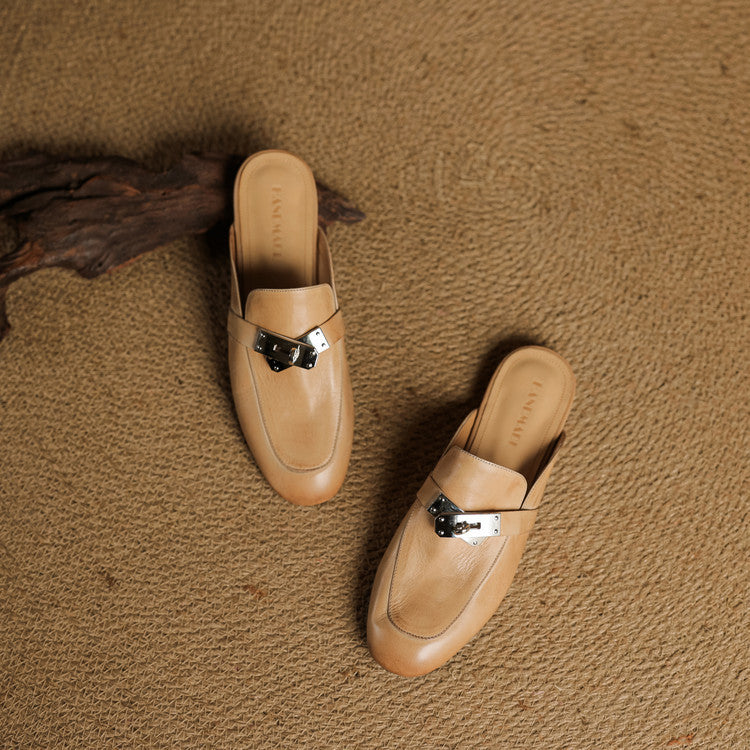 Two tan leather mules with square toe and metallic buckle strap