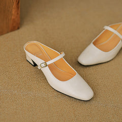 Beige leather mary-jane style mule with gold buckle strap and low block heel.