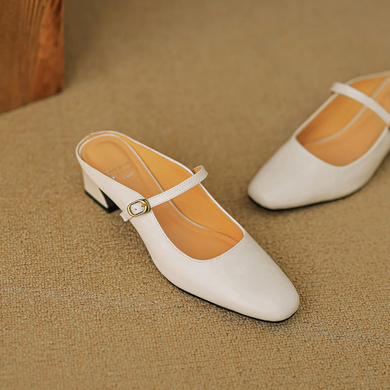Beige leather mary-jane style mule with gold buckle strap and low block heel.