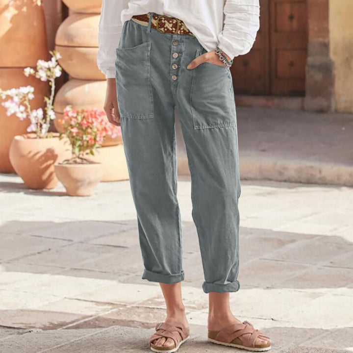Slate blue casual pants with button front, patch pockets, and cuffed ankle hem