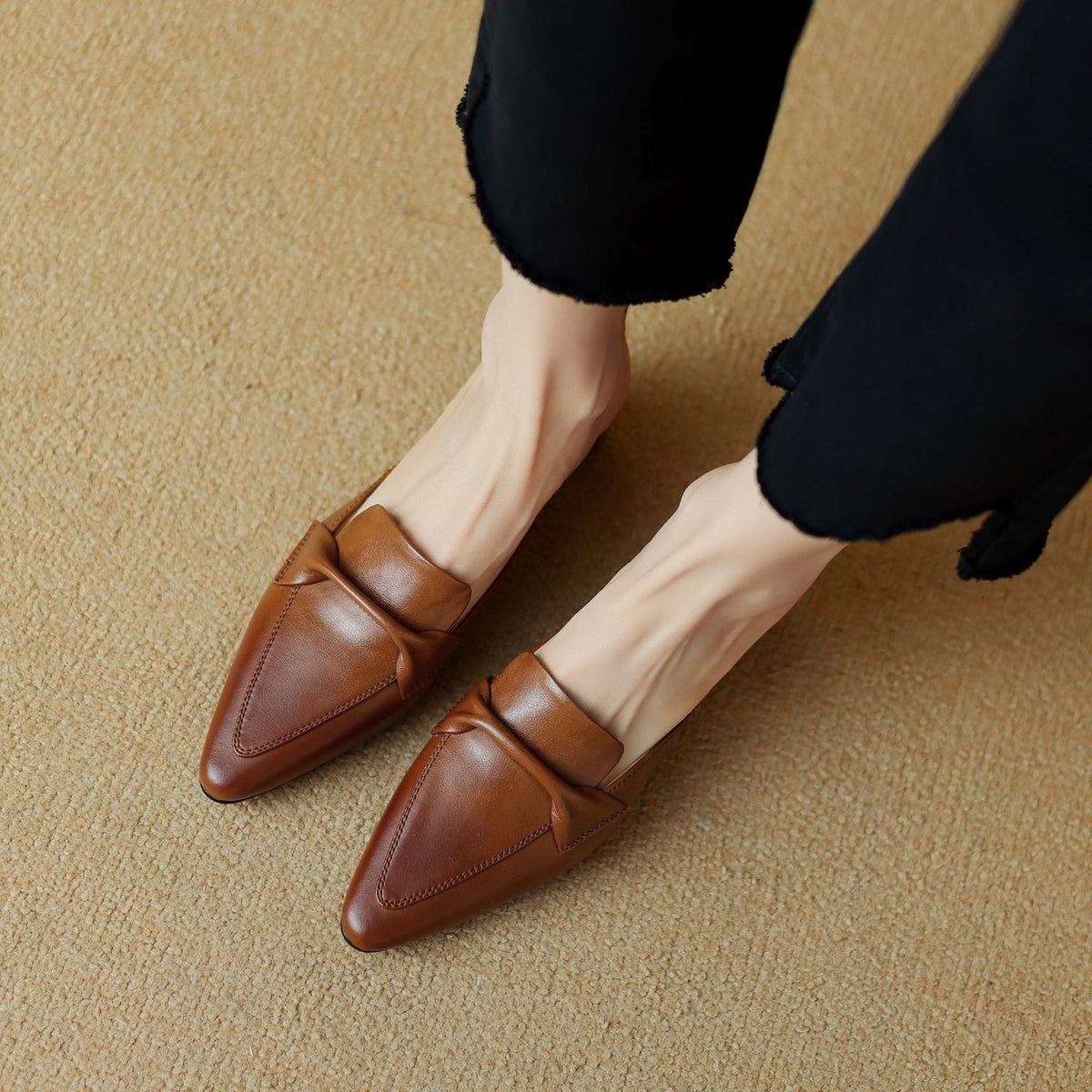 Pair of brown leather pointed mules with strap detail and low block heels
