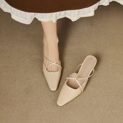 Beige leather mules, crisscross straps and pointed toe with low heel