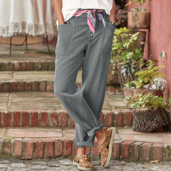 Slate blue casual pants with button fly, slanted pockets, and cuffed ankle hem