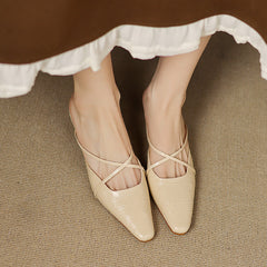 Beige pointed-toe mules with crisscross straps and low heel