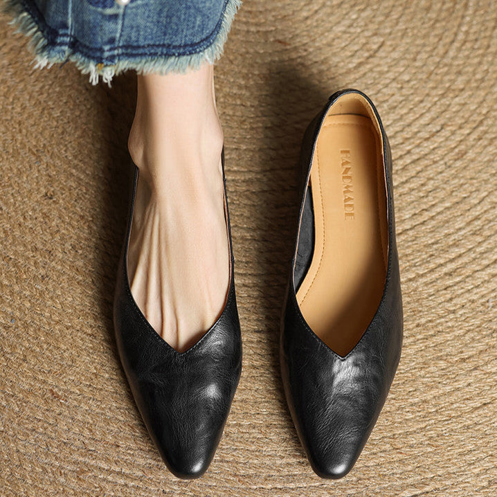 Black leather pointed-toe mules with slip-on V-cut upper and low heel.