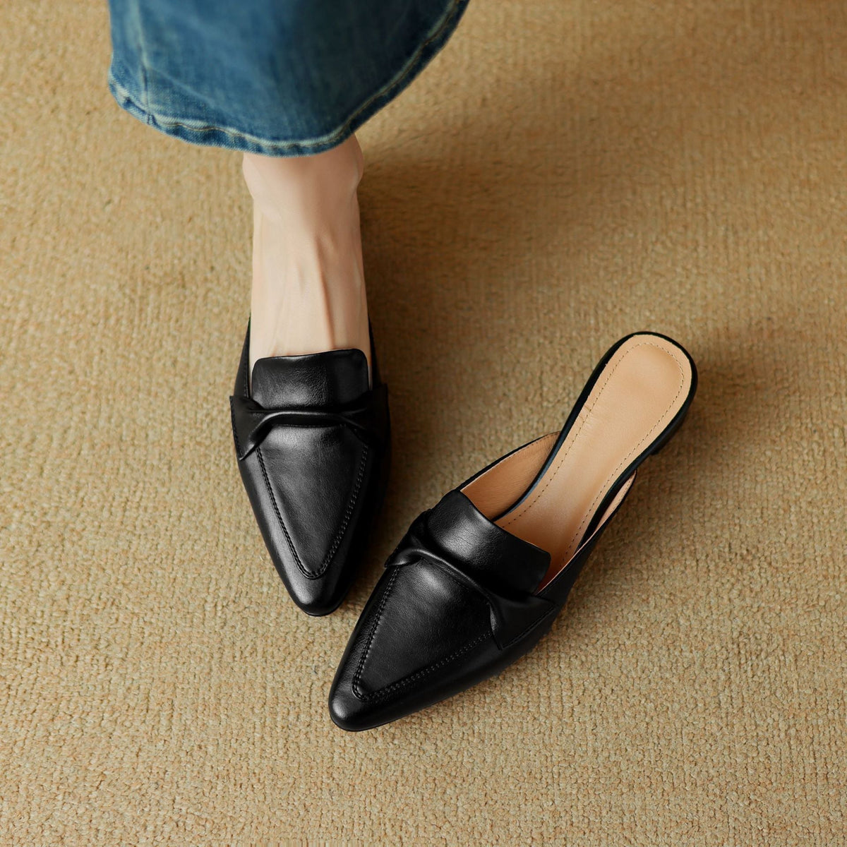 Black genuine leather mule with pointed toe and slip-on design