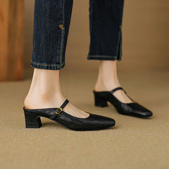 Black leather pointed-arch mule with low block heel and buckle strap