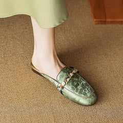 Green genuine leather mules with floral print and bow ornament, low flat sole