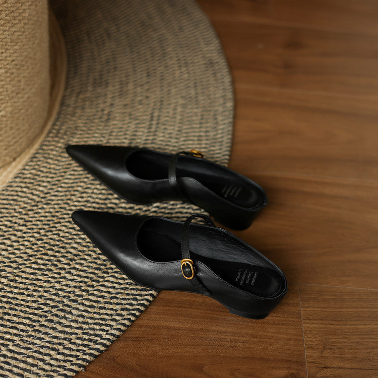 Pair of black genuine leather mules with pointed toe and sling strap, open back.
