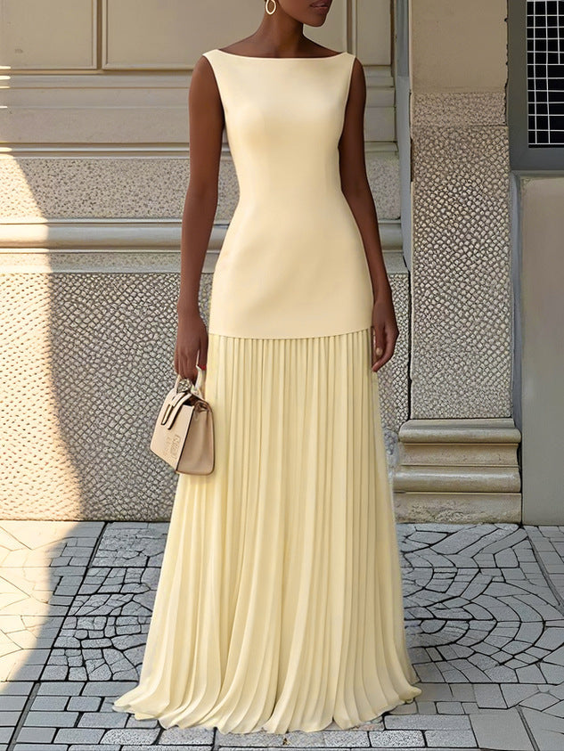 Yellow pleated sleeveless maxi dress with fitted bodice and tiered skirt.