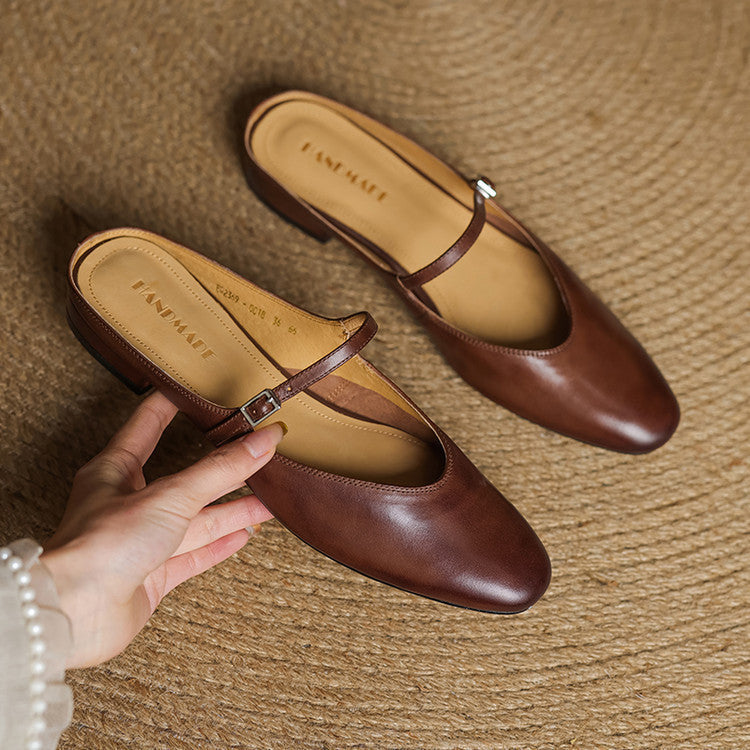 Pair of brown genuine leather mules with buckle strap and almond toe