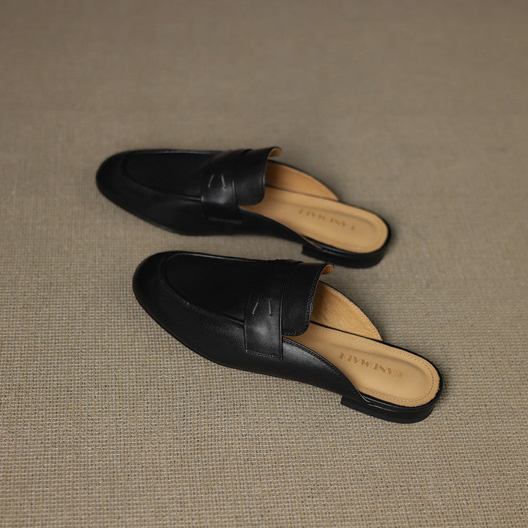 Pair of black genuine leather mules with decorative strap seam and rounded toe
