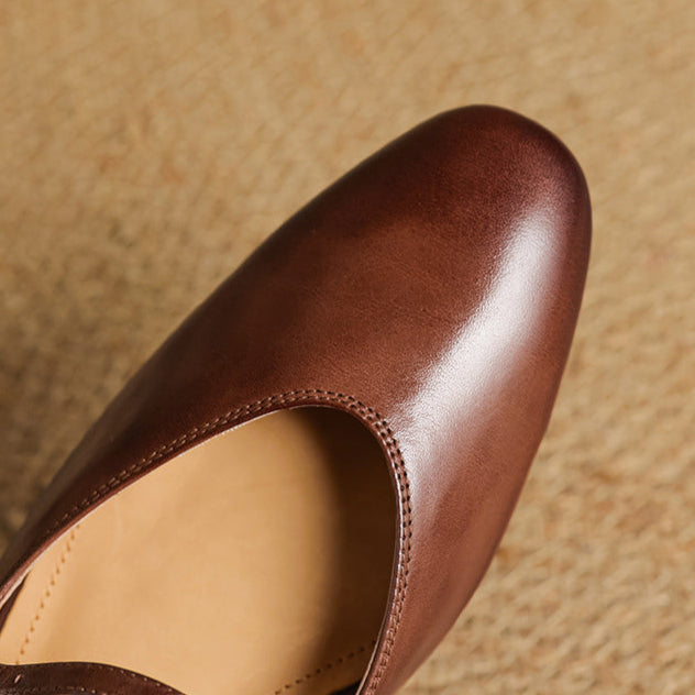 Close-up of brown genuine leather mule toe and curved topline opening