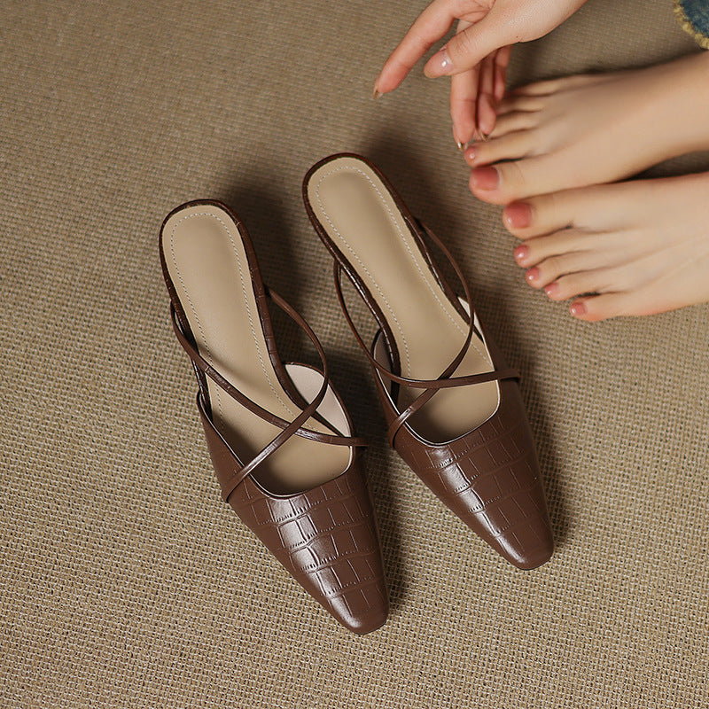 Brown genuine leather mules with crisscross straps, open toe, and low mid heel.