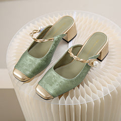 Pair of green genuine leather mules with block heels, gold trim, and pearl chain strap.