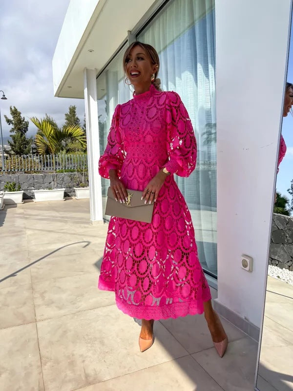Hot pink romantic lace dress with long puff sleeves and allover circular lace pattern.