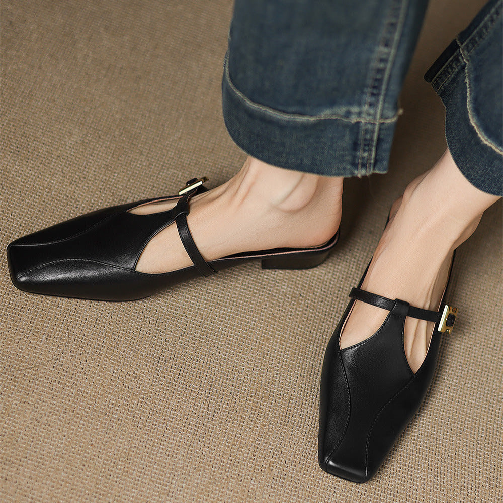 Black leather mules with open toe strap and gold buckle, pointed toe low heel