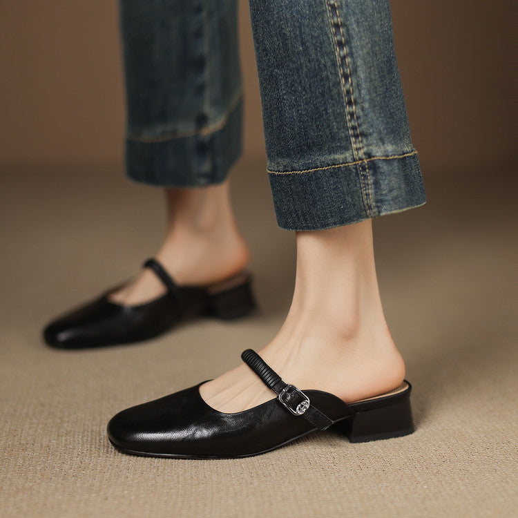 Black leather Mary Jane mule flats with textured ankle strap and buckle closure