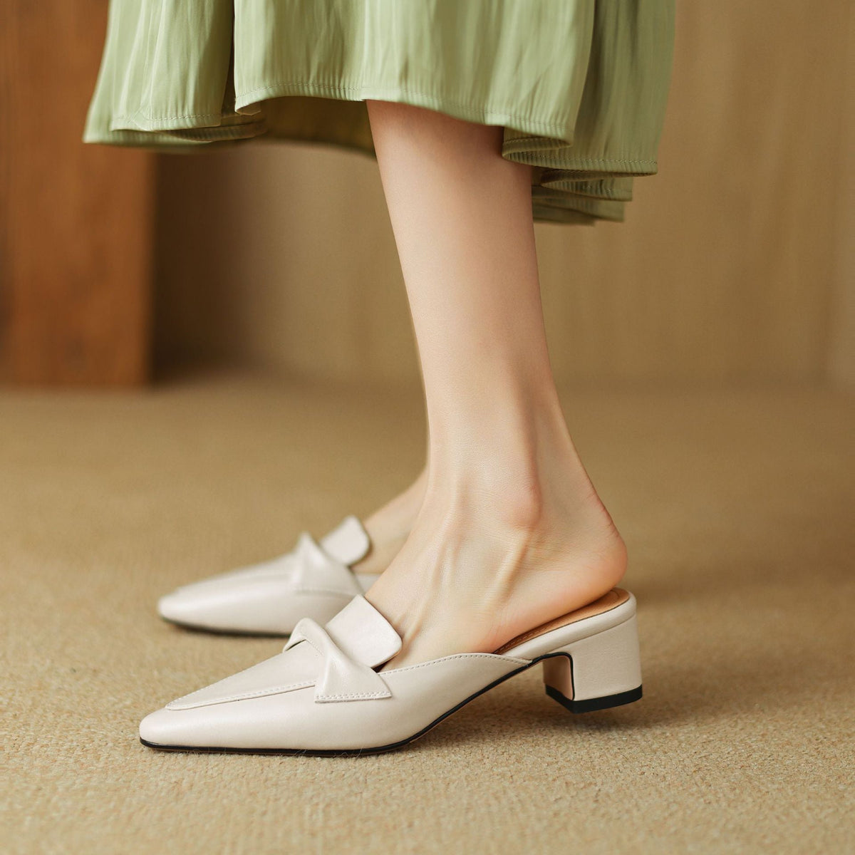 White leather mule with square toe and low block heel, slip-on with strap detail
