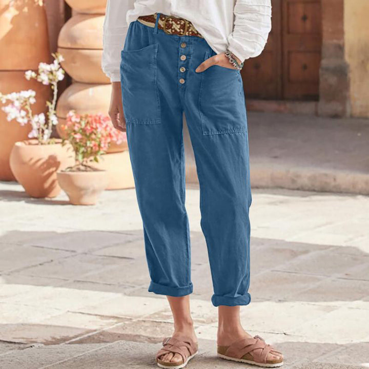 Blue casual pants with button front, patch pockets, and cuffed ankle hem
