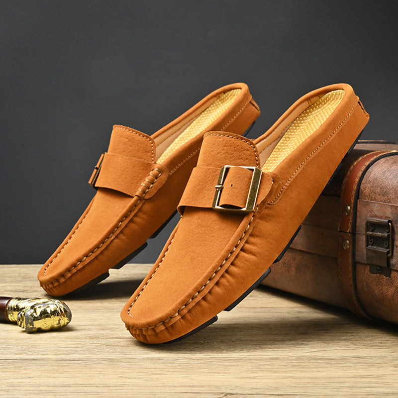 Pair of tan suede mules with metal buckle strap and stitched edges