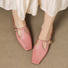 Pink leather mule slides with cutout vamp and gold buckle sling strap, low block heel
